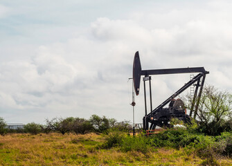 Oil drill in open pasture