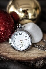 Vintage pocket watch over wood with christmas decoration 