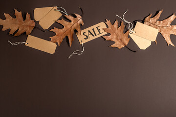 Black Friday Sale. Paper tags, autumn leaves, shopping concept with discounts