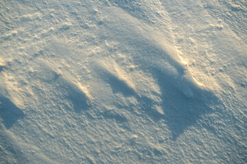 Uneven texture of snow in the sunset light