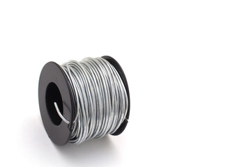 Roll of 14 gauge steel wire on white with copy space