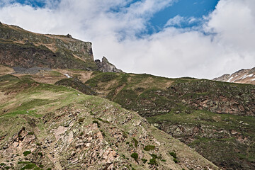 Elbrus mountains in May. Snow, greenery, brown earth
