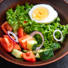 vegetables salad boiled egg cucumber, tomato, onion, lettuce healthy meal food diet snack on the table copy space food background rustic. top view keto or paleo diet