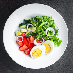 vegetables salad boiled egg cucumber, tomato, onion, lettuce healthy meal food diet snack on the table copy space food background rustic. top view keto or paleo diet