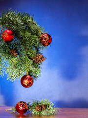 New Year and Christmas branches of fir trees with colorful toys on a colorful fairy-tale...