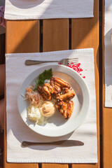 Beautifully served table, grilled chicken wings with vitamin salad of white sauerkraut, top view