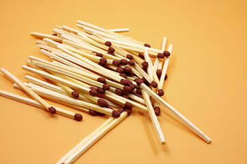 pile of matchstick on yellow background