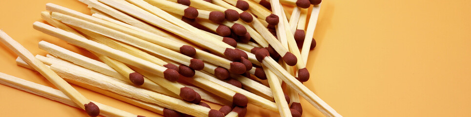 pile of matchstick on yellow background