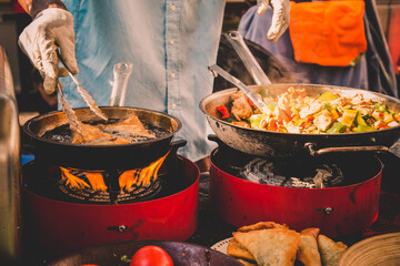 Cheff cooking fusion international cusine on street stall on international street food festival of...