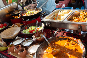 Cheff cooking fusion international cusine on street stall on international street food festival of Odprta kuhna, Open kitchen event, in Ljubljana, Slovenia