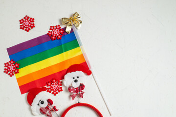 Fototapeta na wymiar LGBT and New Years concept. Rainbow flag and New Year's decor on a white background. Place for your text.