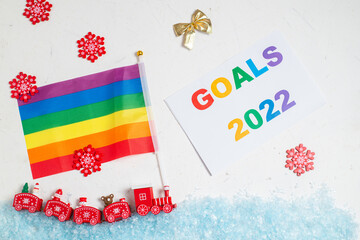 LGBT and New Years goals concept. New Year's steam locomotive with rainbow flag covered with snow.
