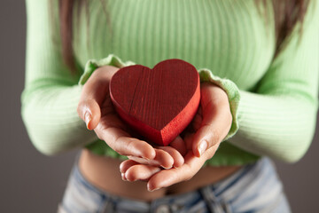 wooden heart  in woman hands
