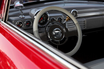 Classic retro beautiful red car. Close up steering wheel