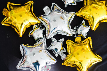 balloons made of foil in the form of stars in gold and silver color