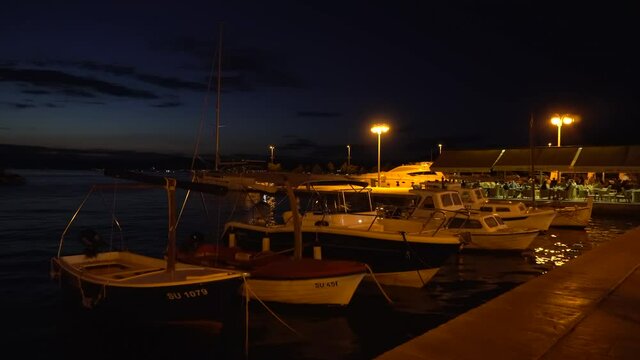 SUPETAR, DALMATIA, CROATIA - AUGUST 30, 2021: Boats in the evening in Supetar in Croatia. Handheld, 4K