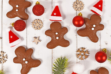 Gingerbread glazed with chocolate in shape of men between Christmas decoration