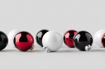 Multiple white, red and black glossy Christmas balls mockup on a seamless grey background.