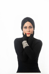 elegant woman made up and dressed in black with turban and gloves on a white background with copy space