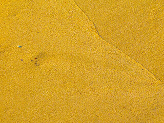 Wet sand with delicate lines created by ocean waves that resemble trend graphs. Illustration concept for business.