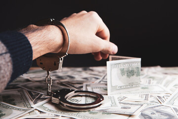 handcuffed at the table with money