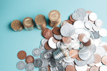 coins in the form of a growing graph and a light bulb on scattered coins