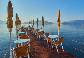 Beach cafe at dawn. Empty tables in a cafe, a sunny morning on the beach.