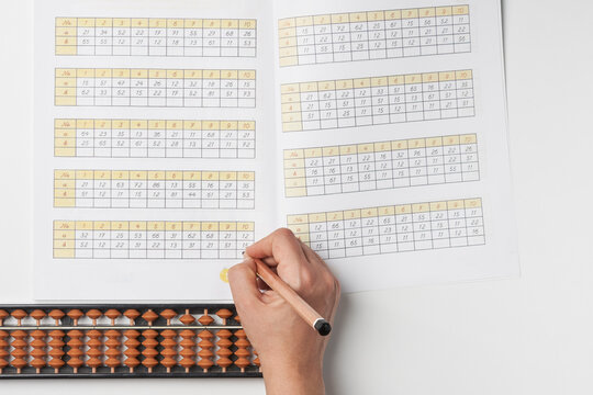 Doing mental math or mental arithmetic. Hand of person using abacus for calculating. Learning to use abacus on mental math courses