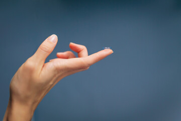 Contact lens on woman finger, Optic health treatment. Ophthalmology and eyes care concept