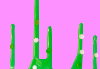 bright green contrasting smudges of icing on a cake on a pink background