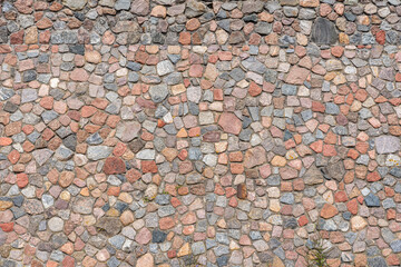 The stone wall is laid out in a flat wall.