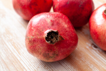 pomegranates fruits arranged on light wooden background