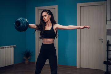 Fototapeta na wymiar Woman training in the gym and using kettlebell