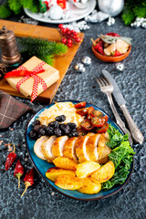 baked chicken breast with potatoes and olives on xmas background