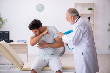 Young male patient visiting old male doctor