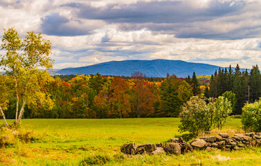 Fall foliage light up the landscape in the Vermont countryside
