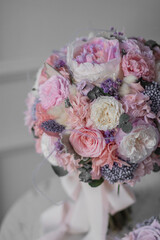 Stylish bridal bouquet and a boutonniere for the groom of preserved flowers. Wedding bouquet of white and pink roses. Close up of wedding bouquet.