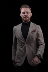 Obraz premium Confident businessman walking forward wearing a causal suit, handsome senior business man hero shot portrait isolated on black