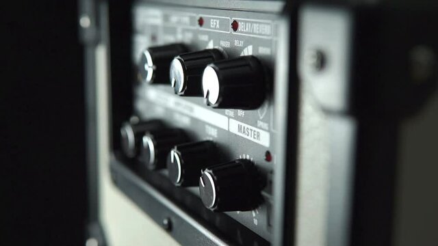 Close-up of an electric guitar amplifier, moving ilumination