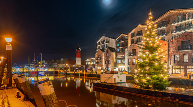 View of of festive lighting and Christmas romantic atmosphere in the B&uuml;sum at night. Nighttime view of B&uuml;sum at Christmas time. Maritime Christmas town. 