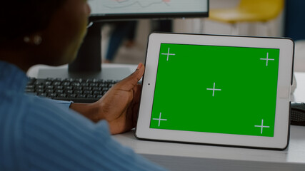 Close up of disabled african worker immobilized in wheelchair looking at digital tablet with green screen chroma key mock up isolated, display comparing graphs from computer working in start up