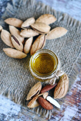 Selective focus. Almonds in shells. Almond oil.