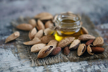 Selective focus. Almonds in shells. Almond oil.