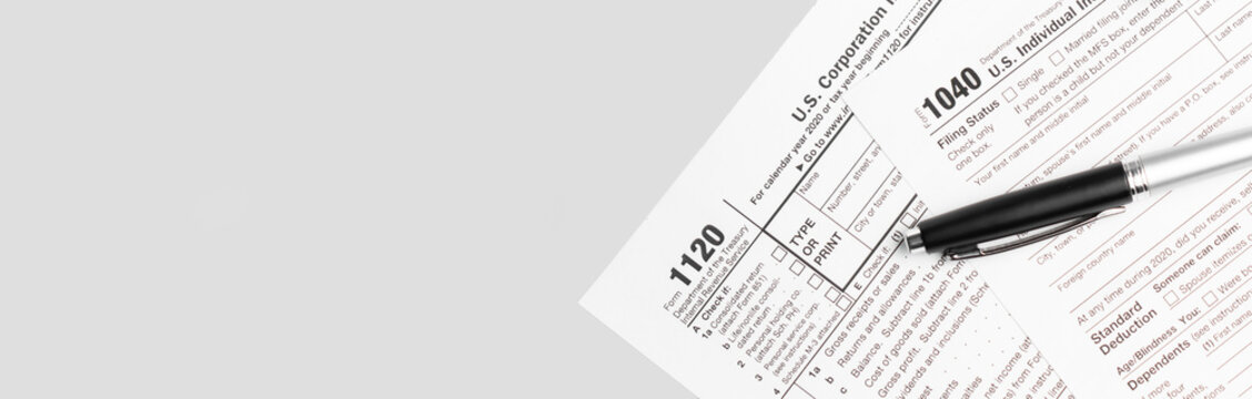 Pen on US TAX form Background. Tax Day concept
