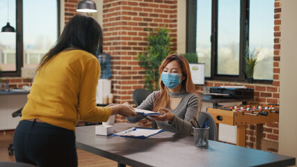 Applicant meeting with HR employee at job interview, discussing about CV and recruitment information. Office worker and candidate talking about hiring and employment during covid 19 pandemic.