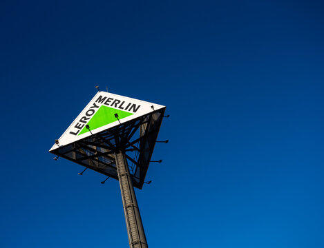 Braga, Portugal - December 14, 2021: Leroy Merlin logo sign on blue sky, it is a French company of large-scale distribution for bricolage construction, gardening, home decoration.