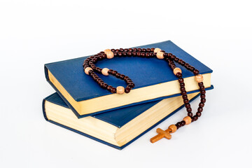 Christian rosary beads with cross and Bible book