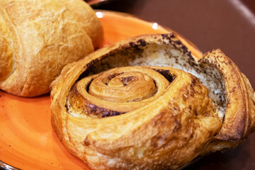 Two ruddy buns on a plate closeup