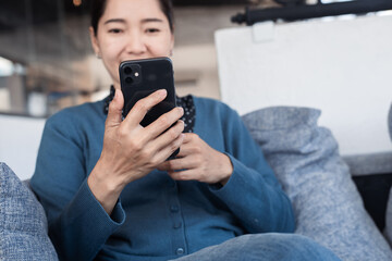 using cell phone hand holding mobile texting message contact us.chatting,search internet information in office.technology device communication connecting