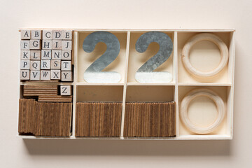 box with alphabet stamp set, objects, and the number 22